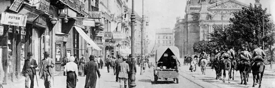Historic Lviv street with pedestrians and horse-drawn traffic.